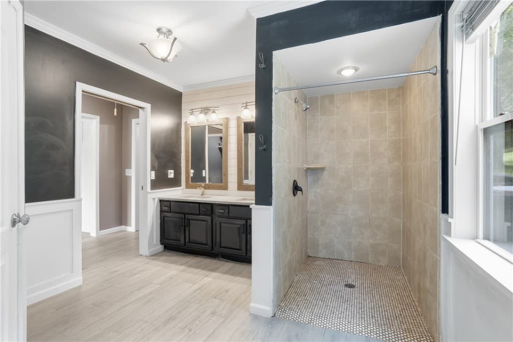 Primary suite bath with a walk-in shower and double vanity