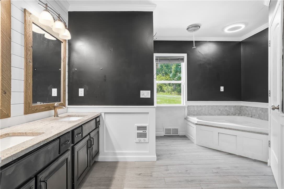 Primary suite bath with double vanity and soaking tub