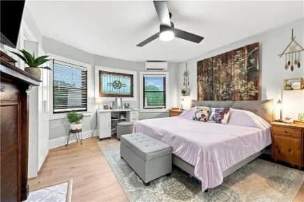 Bedroom with stained-glass windows and a ceiling fan